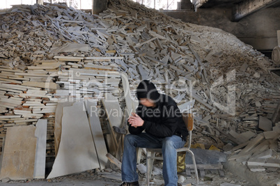 man and pile of broken marble