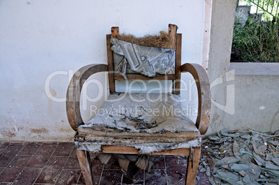 torn armchair and pile of broken glass