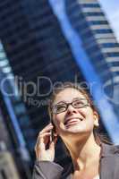 Woman or Businesswoman Talking on Cell Phone in City