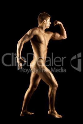 Nude man show athletic body with metal skin