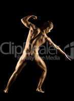Naked strong man posing in gold skin