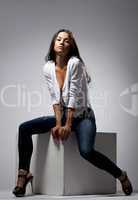 Cute woman sit in jeans and white jacket