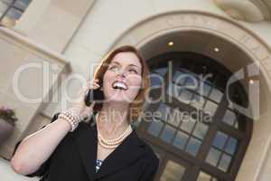 Happy Businesswoman On Cell Phone in Front of City Hall
