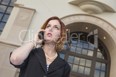 Young Businesswoman On Cell Phone in Front of City Hall