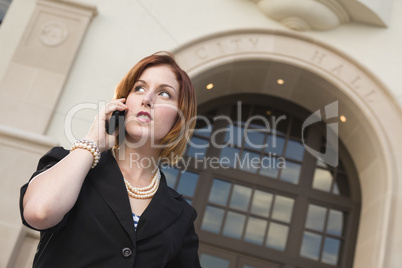 Young Businesswoman On Cell Phone in Front of City Hall