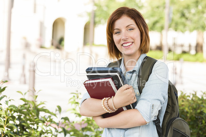 Smiling Young Female Student Outside with Books