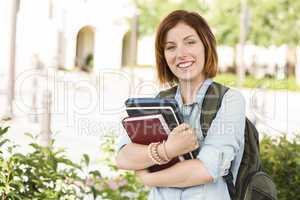 Smiling Young Female Student Outside with Books