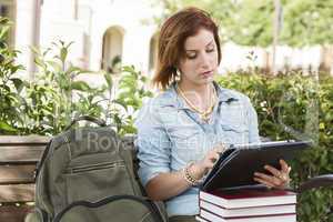 Young Female Student Outside on Bench Using Touch Tablet