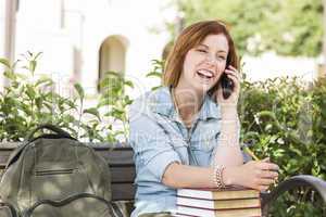 Young Female Student Outside Using Cell Phone Sitting on Bench