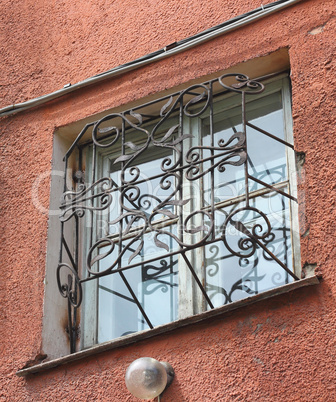 metal forged carved lattice at a plastic white window