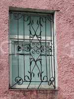 black metal forged carved lattice at a  white window