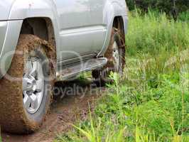 Extreme offroad behind an unrecognizable car in mud