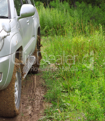 Extreme offroad behind an unrecognizable car in mud