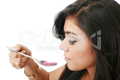 young woman taking syrup close up shoot. Focus in syrup.
