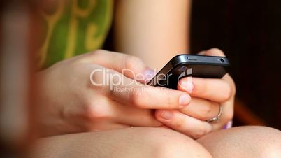 Girl fingers typing on a mobile