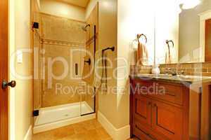 Bathroom with wood cabinet and tile shower.