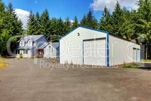 Large workshop warehouse with house and parking lot.