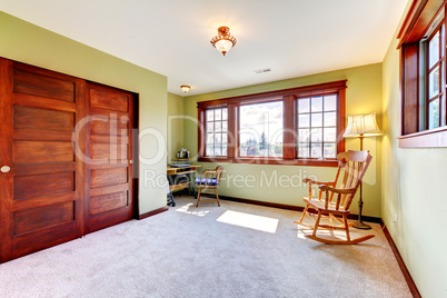 Nice empty bedroom with two windoows and wood closet doors.