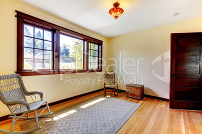 Nice empty room with chair and hardwod floor.