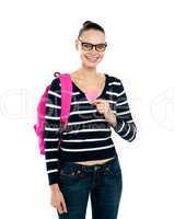 College girl showing pink paper heart to camera