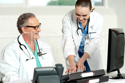Smiling medical team working on computer