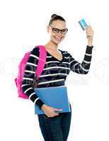 Teenager showing credit card to camera