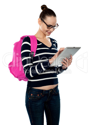 Attractive teenager working on tablet pc