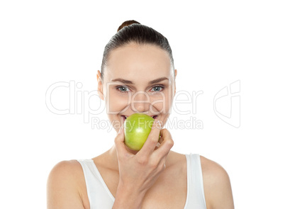 Attractive girl eating fresh juicy green apple