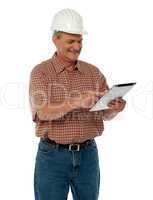 Aged architect using tablet pc
