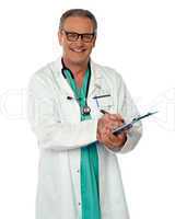 Experienced male doctor making report