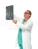 Experienced surgeon looking at x-ray report