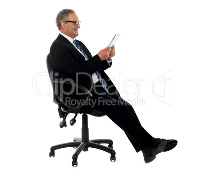 Well dressed corporate male holding wireless tablet