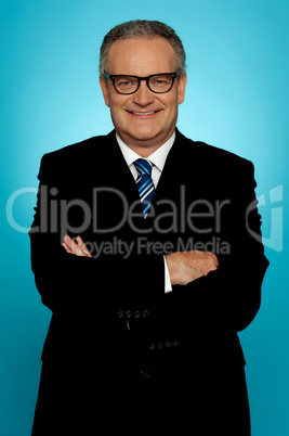 Smiling businessman posing with crossed arms