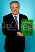 Senior manager showing big green calculator