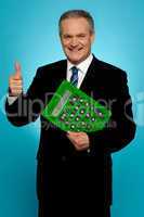 Businessman showing thumbs up, holding calculator