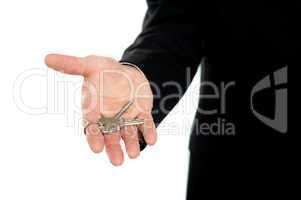 Businessman offering keys, closeup shot