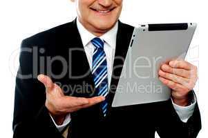 Cropped image of a businessman holding tablet pc