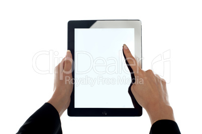 Closeup shot of female finger operating tablet