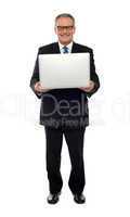 Experienced business person holding laptop