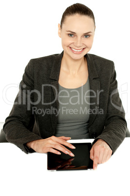 Pretty businesswoman using tablet device