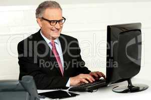 Casual businessman typing on keyboard