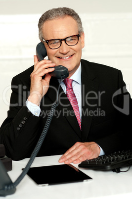 Smiling aged man communicating with his client