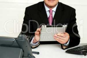 Cropped image of businessman using tablet pc