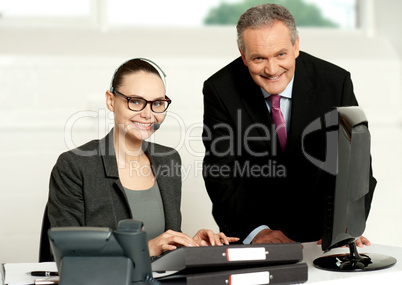 Cheerful corporate people at work in office