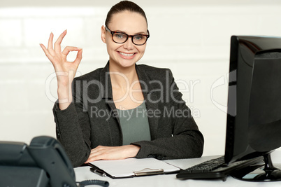 Corporate woman showing excellent gesture