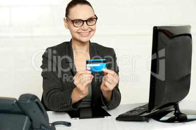 Smiling corporate lady showing credit card