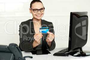 Smiling corporate lady showing credit card