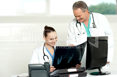 Team of surgeons discussing x-ray report