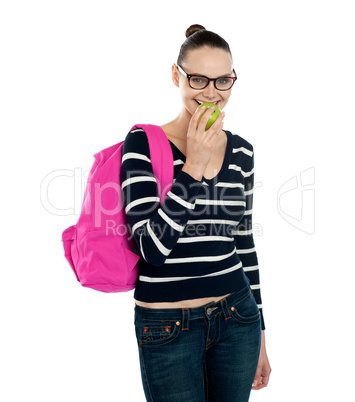College student eating fresh green healthy apple