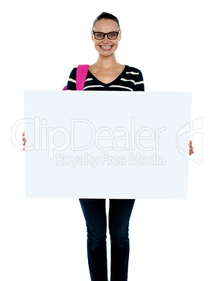 Teenager presenting white blank billboard